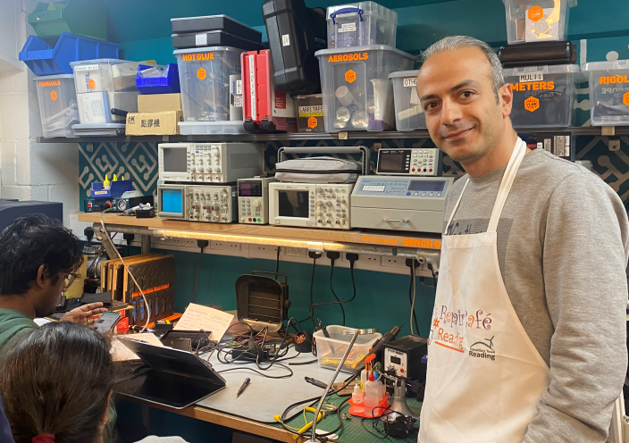 A founder of Reading Repair Cafe standing in the busy workshop